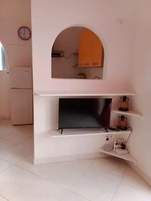 a kitchen with a tv in a white wall at Holiday Properties Vista Do Mar - Wi-fi in Santa Maria