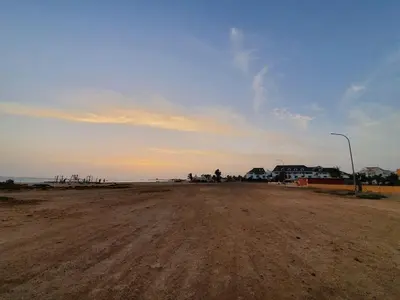 a dirt road in front of the ocean with a street light at Holiday Properties Vista Do Mar - Wi-fi in Santa Maria
