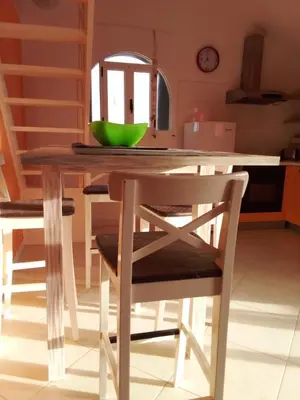 a wooden table with a green bowl on top of it at Holiday Properties Vista Do Mar - Wi-fi in Santa Maria