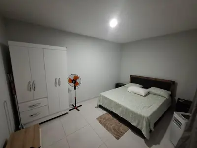 a bedroom with a bed and a closet and a fan at One-bedroom apartment rental - Chã de Alecrim - SV in Mindelo