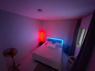 a bedroom with a bed and a red light at One-bedroom apartment rental - Chã de Alecrim - SV in Mindelo