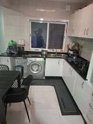 a kitchen with a sink and a washing machine at One-bedroom apartment rental - Chã de Alecrim - SV in Mindelo