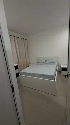 a bedroom with a bed in a white room at Morabeza Home in Praia