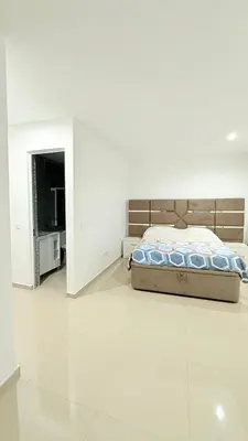 a bedroom with a bed in a white room at Morabeza Home in Praia