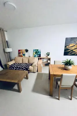 a living room with a couch and a table at Shared Room with Balcony in Praia 5 Minute Walk to Beach in Praia