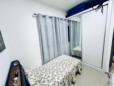 a small bedroom with a bed and a window at Shared Room with Balcony in Praia 5 Minute Walk to Beach in Praia