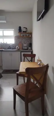 a kitchen with a wooden table and chairs in a room at Studio Sol e Sal in Santa Maria