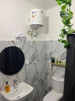 a bathroom with a white toilet and a sink at Studio Sol e Sal in Santa Maria