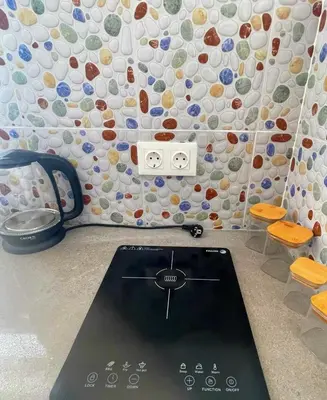 a stove in a room with a wall of plates at Studio Sol e Sal in Santa Maria
