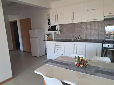 a kitchen with a table with christmas decorations on it at O Meu Aconchego em Montsú in Prainha
