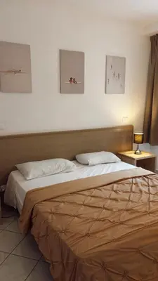 a large bed in a room with three pictures on the wall at Verdes Anos - local accommodation in Santa Maria in Santa Maria