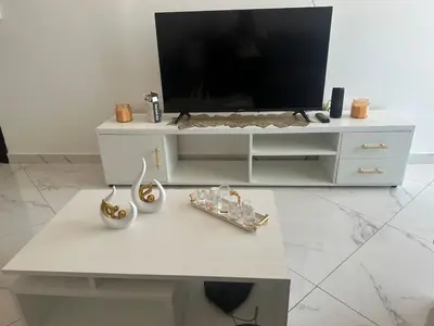 a living room with a white table with a tv at Bestview of Palmarejo in Praia