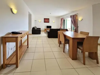 a living room with a table and a couch at 1 bedroom apartment in Vila Verde Resort in Santa Maria