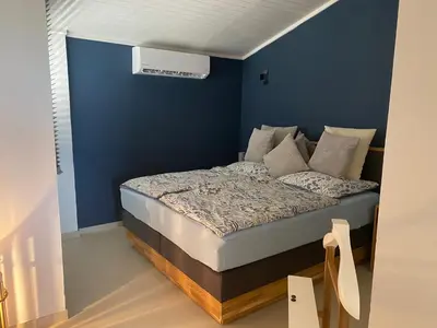 a bedroom with a bed with a blue wall at Penthouse Lieblingsplatz - Favorite place frontline in Sal Rei