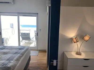 a bedroom with a bed and a view of the ocean at Penthouse Lieblingsplatz - Favorite place frontline in Sal Rei