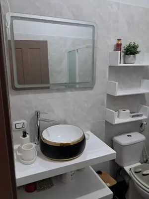 a bathroom with a toilet and a large mirror at T1 Cá Djana in Sal Rei