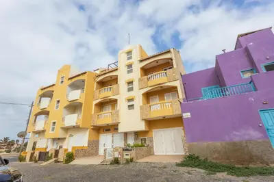 a building with purple and yellow at Casa do Sal - AC, Free Wi-Fi, Near Beach in Santa Maria