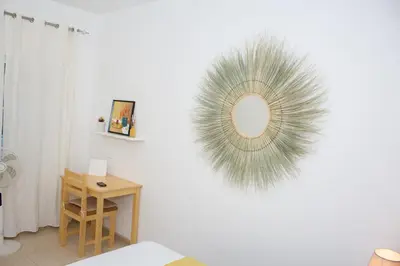 a white room with a mirror on the wall at Morabeza T2 City Center in Mindelo