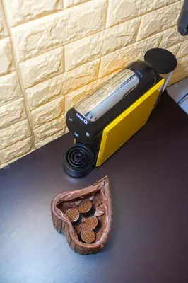 a toaster sitting next to a basket of cookies at Studio Morna City Center in Mindelo
