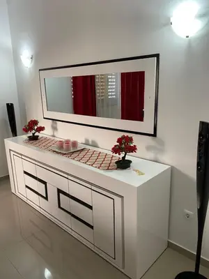 a bathroom with a mirror and a counter with flowers on it at Casa Melissa in Ponta do Sol