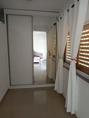 a room with white curtains and a mirror at Casa Melissa in Ponta do Sol