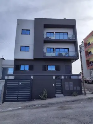 a tall building with a garage in front of it at FreLux Urban Studio in Praia