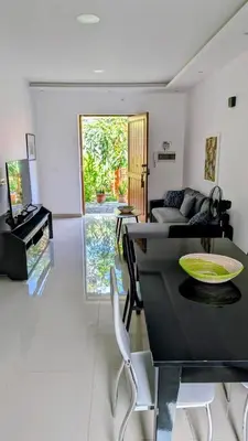 a living room with a table and a couch at Nos Kaza in Cidade Velha