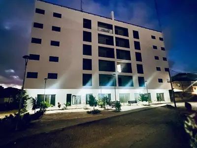 a large white building with a lot of windows at Bright Modern Apart Mountain View, 5 Min to Beach in Praia