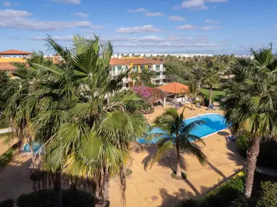 an aerial view of a resort with a pool and palm trees at Studio with Pool & Near the Beach Vila Verde in Santa Maria