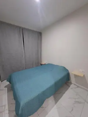 a bedroom with a blue bed in a room at Ocean Spirit Mindelo Apartment in Mindelo