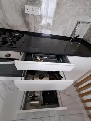 an open drawer in a kitchen next to a stove at Ocean Spirit Mindelo Apartment in Mindelo