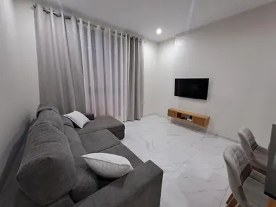 a living room with a couch and a flat screen tv at Ocean Spirit Mindelo Apartment in Mindelo
