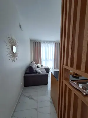a living room with a couch in front of a window at Ocean Spirit Mindelo Apartment in Mindelo