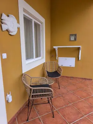 a room with two chairs and a window at Maio Sweet Tartaruga in Vila do Maio