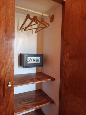 a small television in a closet with wooden shelves at Maio Sweet Tartaruga in Vila do Maio