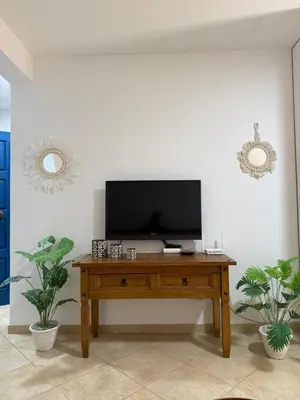 a living room with a television on a wooden table at Santa Maria Firenze 1 by RPG Group in Santa Maria
