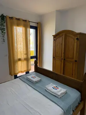 a bedroom with a bed with two towels on it at Santa Maria Firenze 1 by RPG Group in Santa Maria