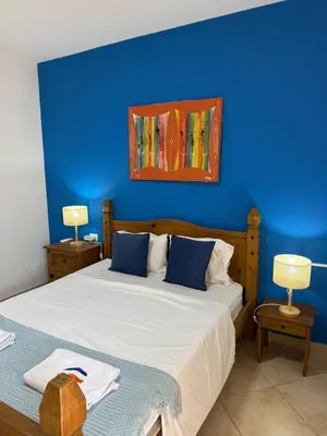a bedroom with a blue wall and a bed at Santa Maria Firenze 1 by RPG Group in Santa Maria