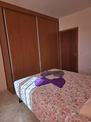 a bedroom with a bed with a purple bow on it at Golden Flow in Espargos