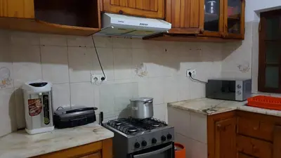 a kitchen with a stove and a microwave at Topklass homes in Praia