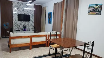 a living room with a bed and a table at Topklass homes in Praia