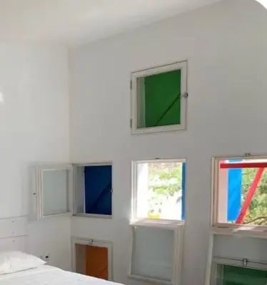 a room with four windows in a white wall at Central studio Nomad friendly 1B in Mindelo