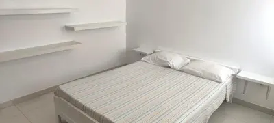 a white room with a bed with two pillows at Pires's House in Mindelo