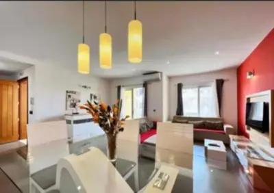 a living room with a glass table and a couch at Apartamento Vieira in Santa Maria