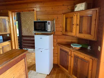 a kitchen with a refrigerator and a microwave at Casa TROPIKAL Maio Ponta Preta in Vila do Maio