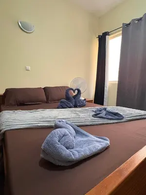 a bedroom with two beds with towels on them at P&SGuestHouse in Espargos