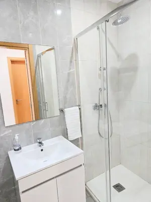 a bathroom with a white sink and a shower at Feeling Santa Maria in Santa Maria