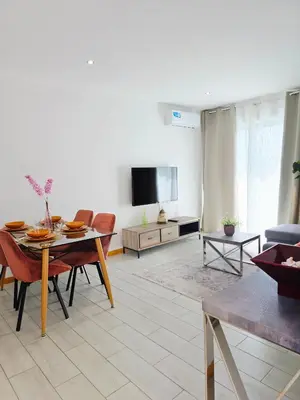 a living room with a table and a tv at Feeling Santa Maria in Santa Maria