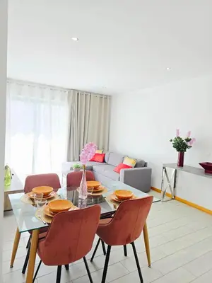 a living room with a glass table and chairs at Feeling Santa Maria in Santa Maria
