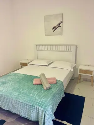 a bedroom with a bed with two towels on it at Encanto do Mar in Santa Maria